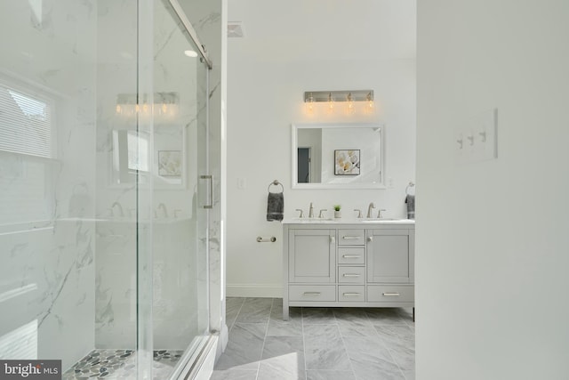 full bathroom featuring a marble finish shower, marble finish flooring, and vanity