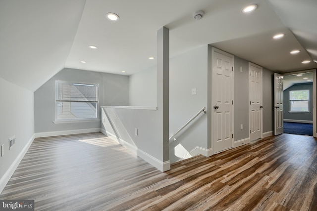 bonus room with wood finished floors, baseboards, recessed lighting, and lofted ceiling