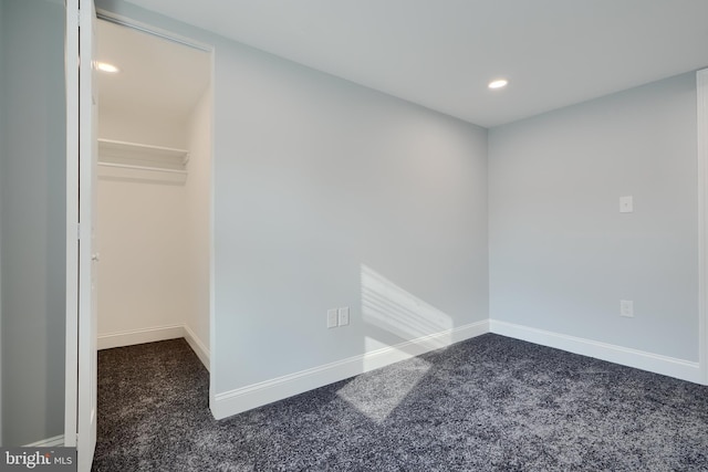 carpeted empty room featuring recessed lighting and baseboards