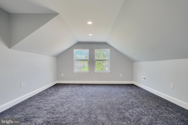 bonus room with dark carpet, baseboards, lofted ceiling, and recessed lighting