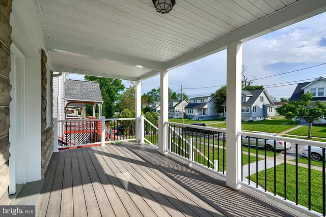 deck featuring a residential view and a yard