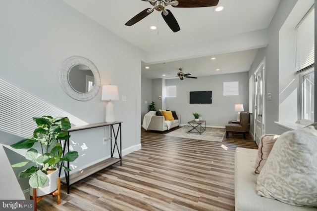 living room featuring ceiling fan, recessed lighting, wood finished floors, and baseboards