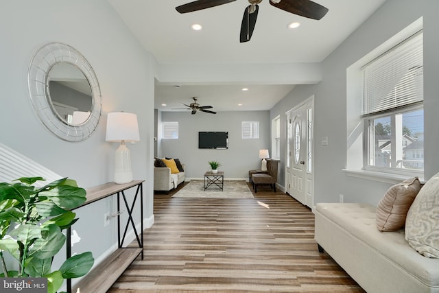 living room featuring a ceiling fan, recessed lighting, wood finished floors, and baseboards