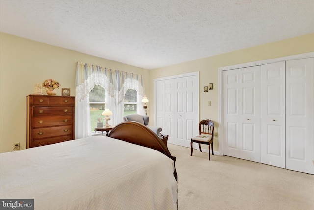 3467 Gleneagles Dr, Chambersburg, PA 17202 - bedroom featuring two closets, carpet flooring, and a textured ceiling