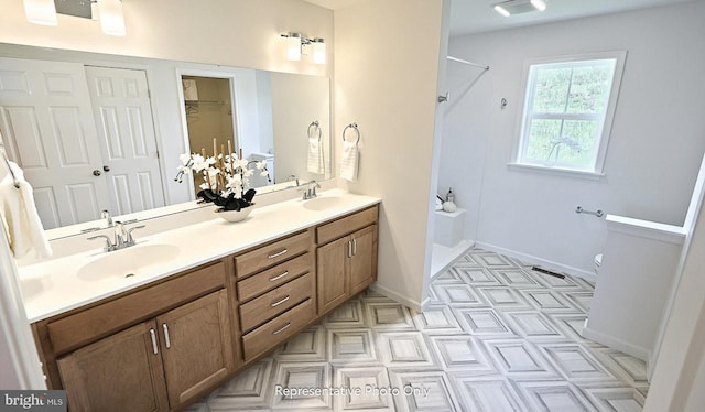416 Allegheny Dr, Mechanicsburg, PA 17055 - bathroom featuring a shower, double vanity, toilet, and baseboards