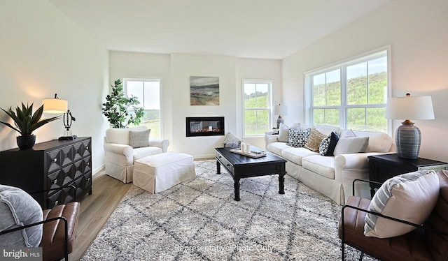 416 Allegheny Dr, Mechanicsburg, PA 17055 - living area with wood finished floors, a glass covered fireplace, and baseboards