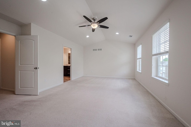 unfurnished living room with light carpet, a ceiling fan, lofted ceiling, baseboards, and recessed lighting