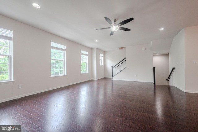unfurnished living room with a ceiling fan, dark wood-type flooring, recessed lighting, and baseboards