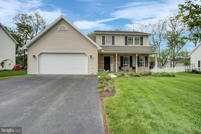 traditional-style home featuring a porch, asphalt driveway, a garage, and a shingled roof