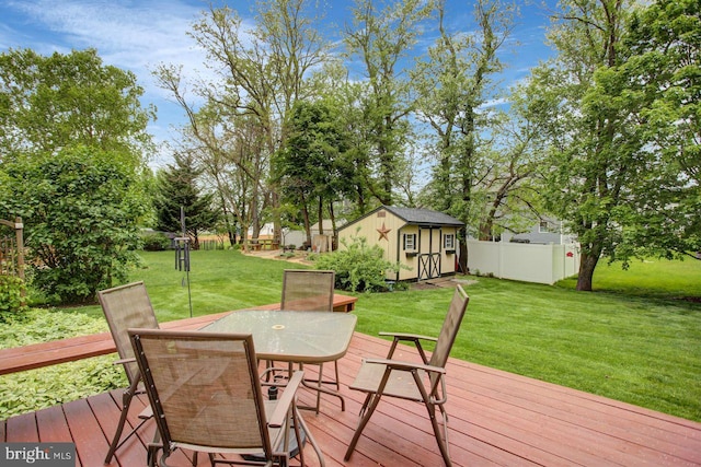 wooden deck featuring outdoor dining space, a storage unit, and an outdoor structure