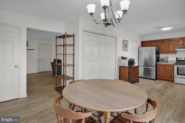 dining space featuring a chandelier and light wood-type flooring