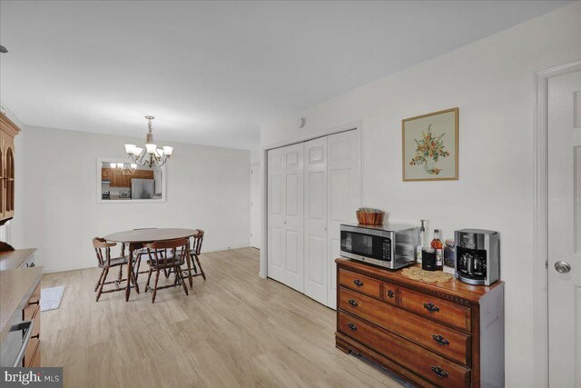dining area featuring a chandelier and light wood finished floors