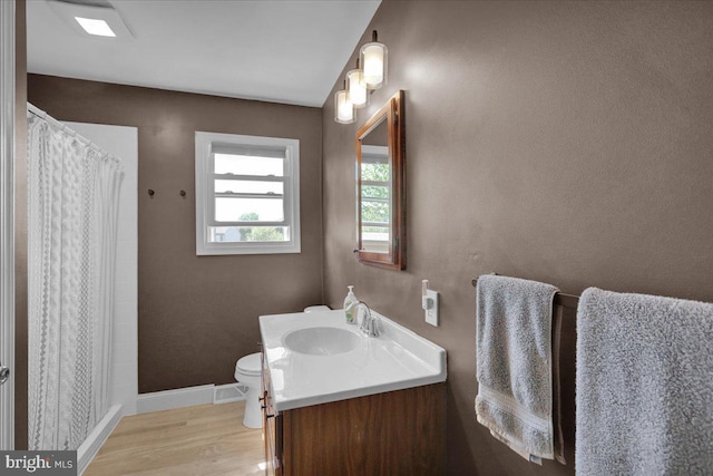 full bathroom with vanity, baseboards, wood finished floors, toilet, and curtained shower