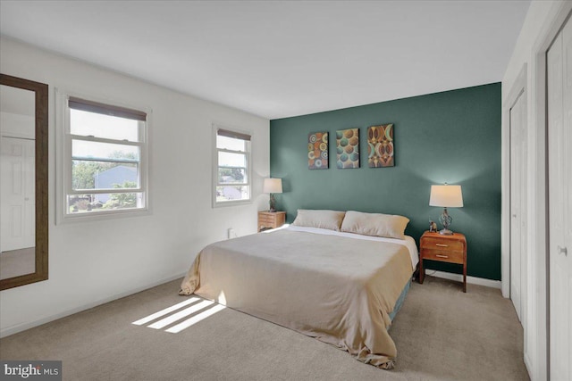 bedroom featuring carpet floors and baseboards