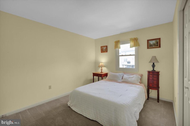 bedroom featuring carpet and baseboards