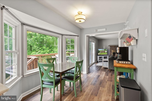 dining space with healthy amount of natural light, baseboards, and a fireplace