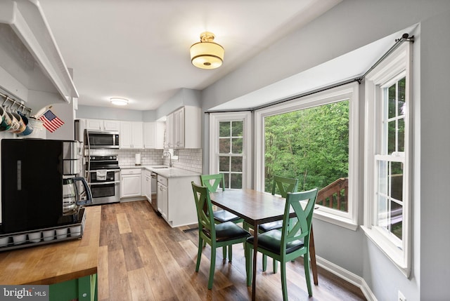 dining space featuring light wood finished floors