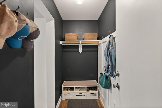 mudroom featuring baseboards and wood finished floors