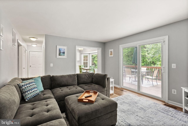 living room featuring light wood-style floors and baseboards