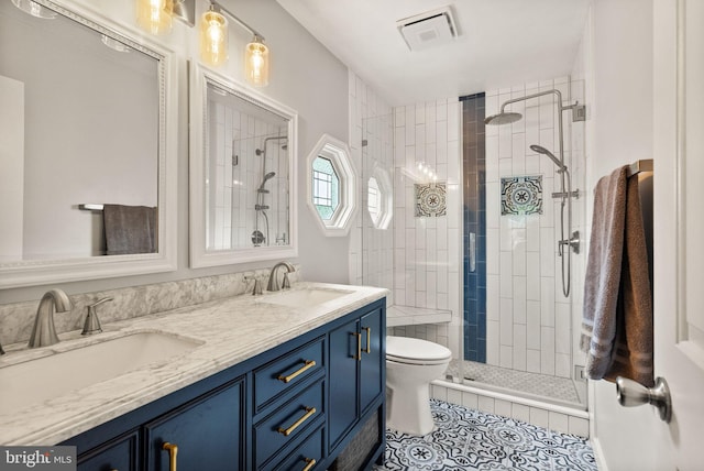 bathroom with tile patterned flooring, a stall shower, double vanity, and toilet
