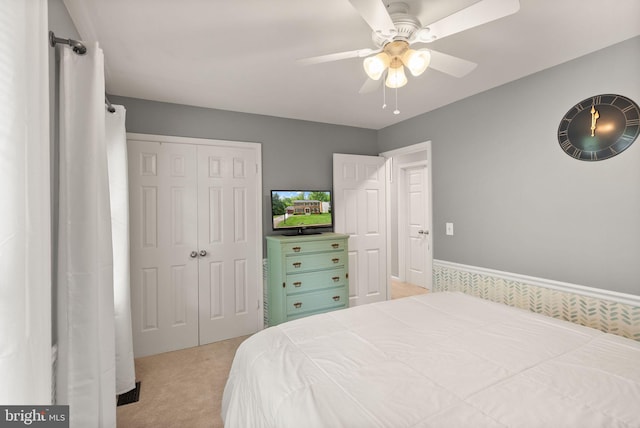 bedroom with light carpet, a closet, and ceiling fan