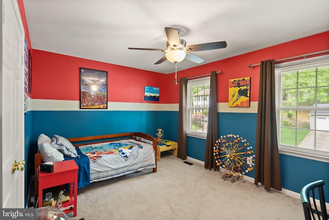 carpeted bedroom featuring baseboards and a ceiling fan