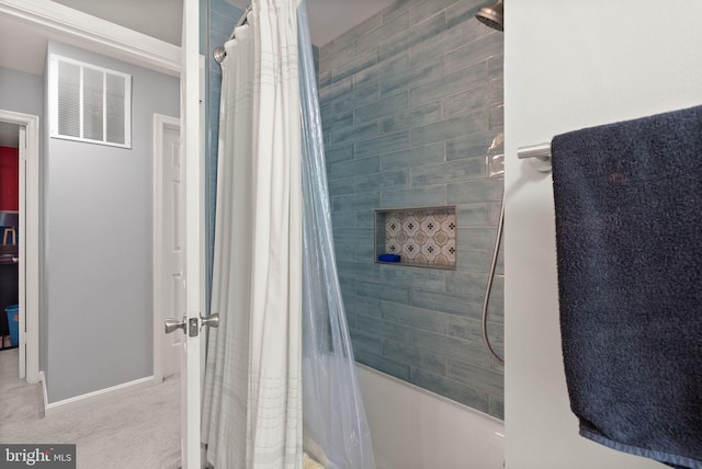 bathroom featuring baseboards and shower / tub combo