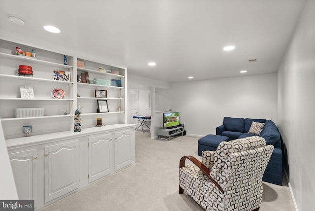sitting room with light carpet, recessed lighting, and baseboards