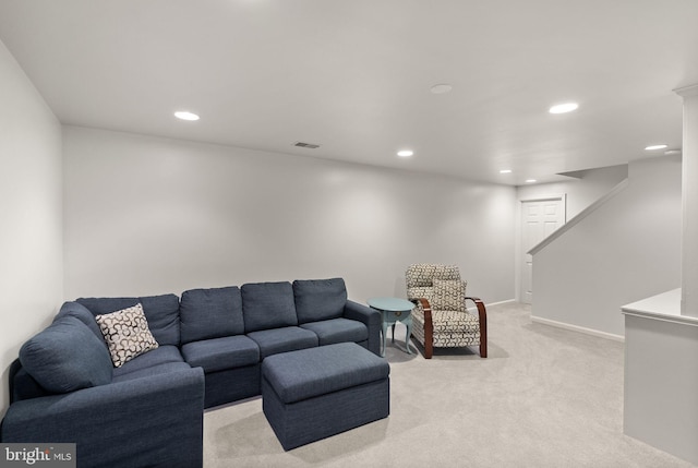 living area featuring recessed lighting, light colored carpet, baseboards, and stairway