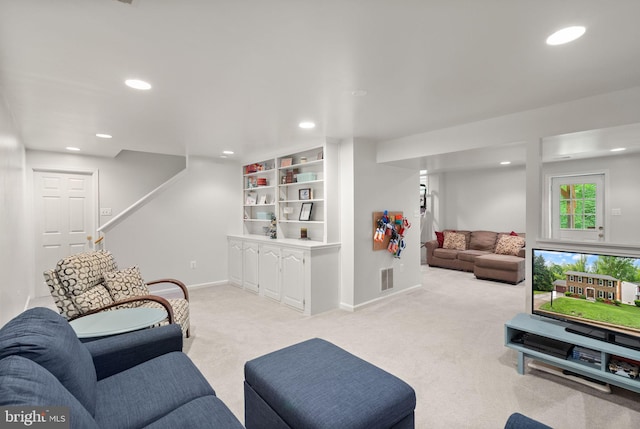 carpeted living area featuring recessed lighting and baseboards