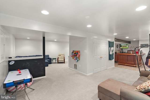 recreation room with light carpet, recessed lighting, and baseboards