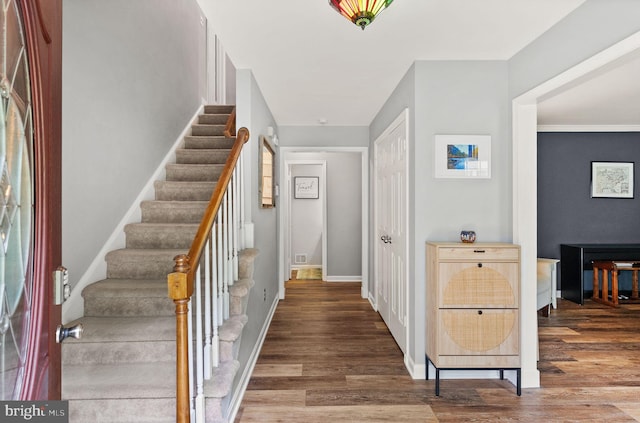 entryway featuring wood finished floors, stairway, and baseboards