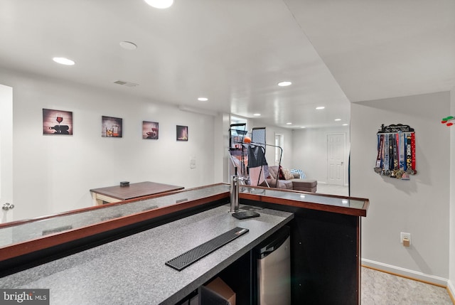 indoor bar featuring recessed lighting, stainless steel dishwasher, and baseboards