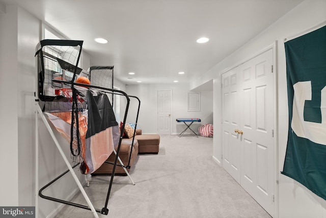 exercise room featuring carpet floors, recessed lighting, and baseboards
