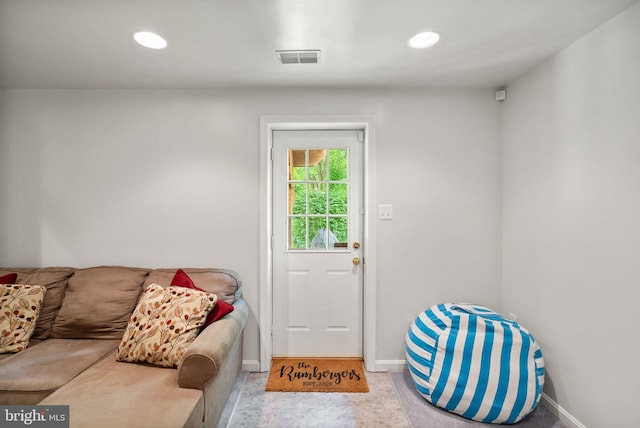 doorway to outside featuring baseboards and recessed lighting