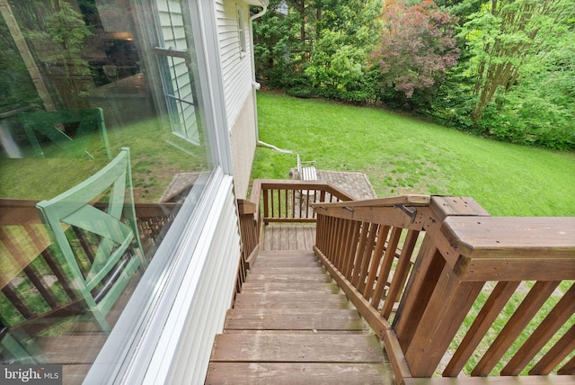 wooden deck featuring a yard