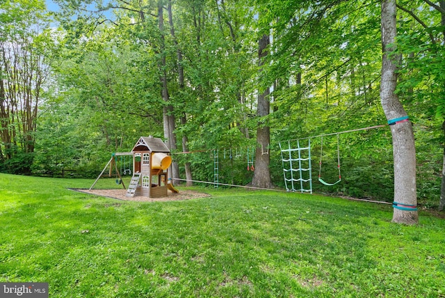 view of green lawn with a playground