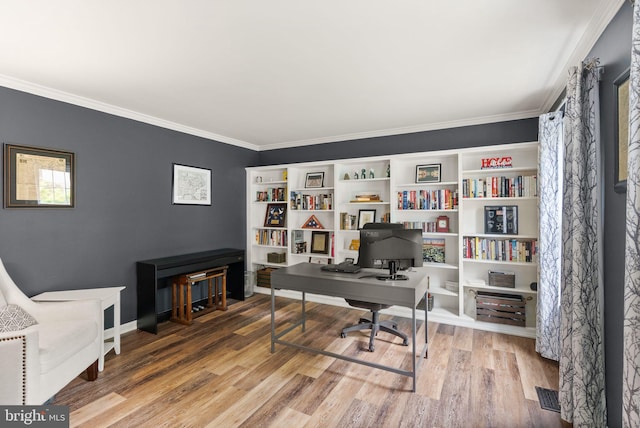 office space with ornamental molding and wood finished floors