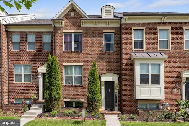 townhome / multi-family property featuring brick siding