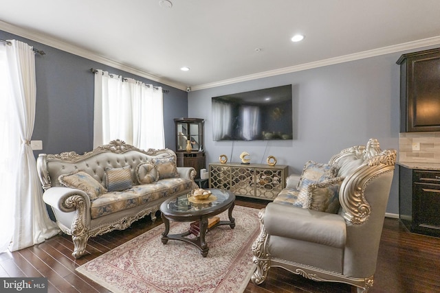 living area featuring dark wood-type flooring, ornamental molding, and recessed lighting