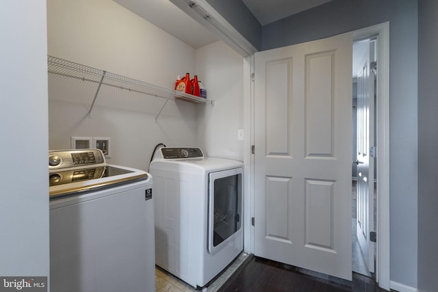 laundry area featuring separate washer and dryer and dark wood finished floors