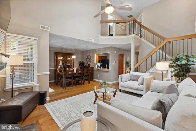 52 Kettlebrook Dr, Mount Laurel, NJ 08054 - living room with a ceiling fan, wood finished floors, stairs, and a towering ceiling