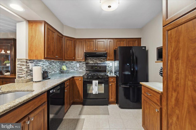 52 Kettlebrook Dr, Mount Laurel, NJ 08054 - kitchen featuring black appliances, under cabinet range hood, tasteful backsplash, and brown cabinetry