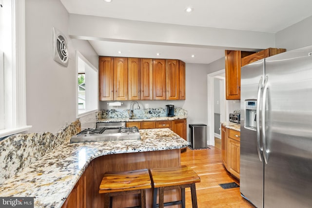 416 S Adams St, Arlington, VA 22204 - kitchen with appliances with stainless steel finishes, recessed lighting, light wood finished floors, light stone counters, and a sink