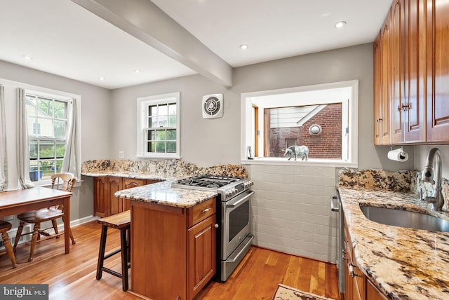 416 S Adams St, Arlington, VA 22204 - kitchen featuring high end range, brown cabinetry, light wood-style flooring, a sink, and recessed lighting