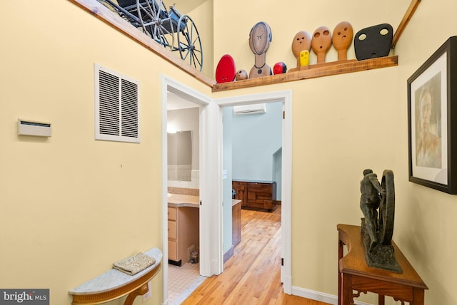416 S Adams St, Arlington, VA 22204 - corridor featuring a wall unit AC, light wood-style floors, and baseboards