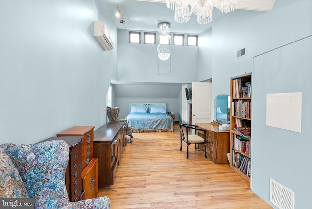 416 S Adams St, Arlington, VA 22204 - bedroom featuring an AC wall unit, a towering ceiling, a chandelier, and wood finished floors