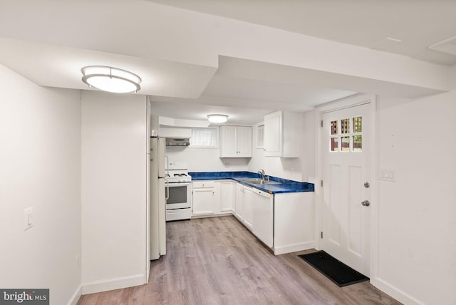 416 S Adams St, Arlington, VA 22204 - kitchen featuring light wood-type flooring, white appliances, under cabinet range hood, white cabinetry, and dark countertops