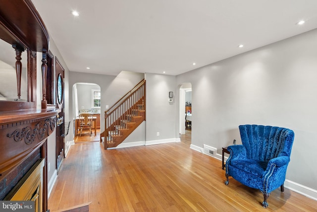 416 S Adams St, Arlington, VA 22204 - sitting room featuring arched walkways, stairway, light wood finished floors, baseboards, and recessed lighting