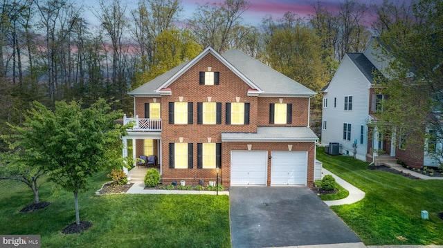 10701 Monocacy Way, Manassas, VA 20112 - colonial house featuring central AC unit, a balcony, driveway, and brick siding